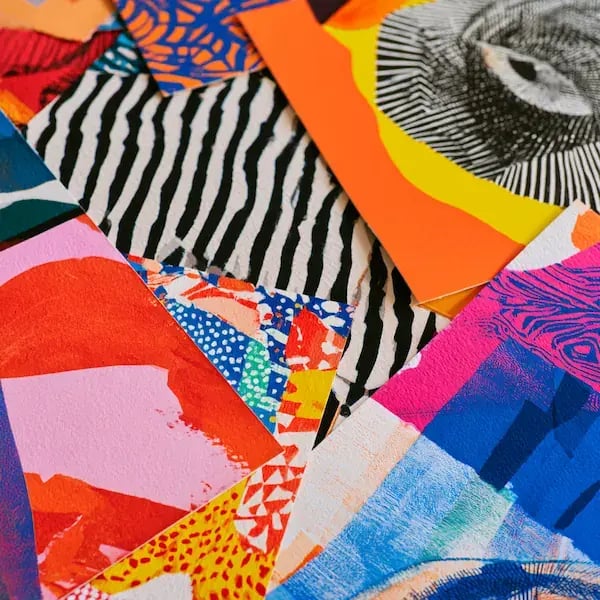 Colorful abstract printed materials layered together with bold patterns, stripes and geometric shapes.